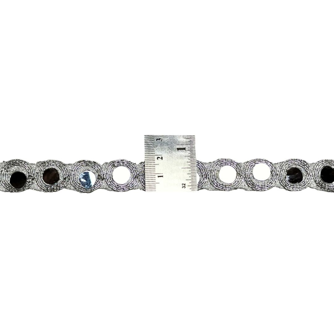 Metallic chain with a ruler for scale on a white background